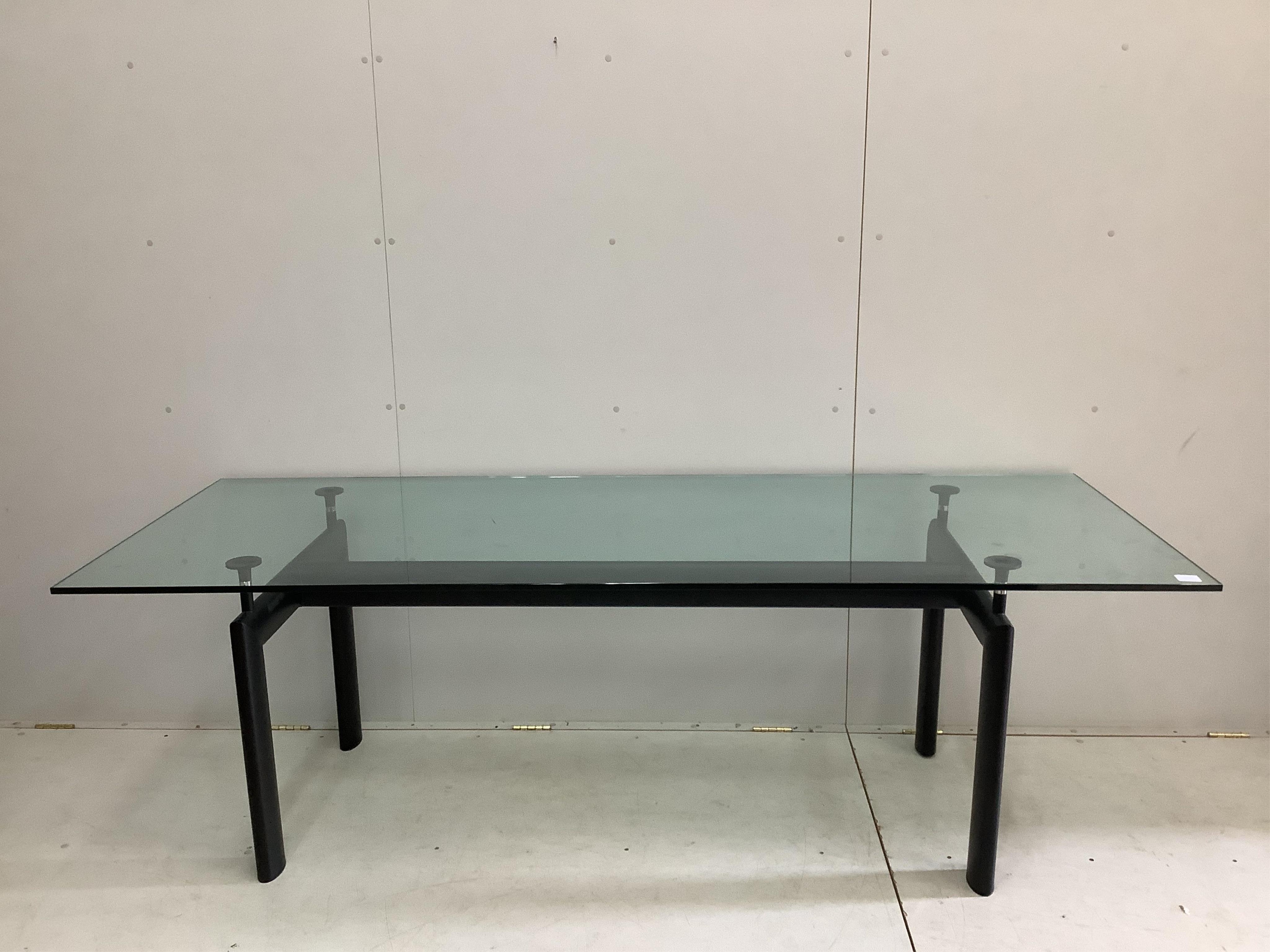 A Corbusier design LC6 style dining table with glass top, width 225cm, depth 85cm, height 72cm